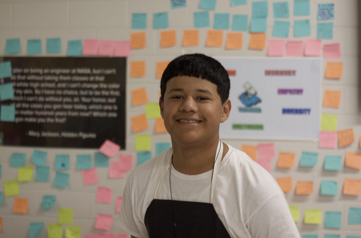 Student Smiling in front of sticky note wall