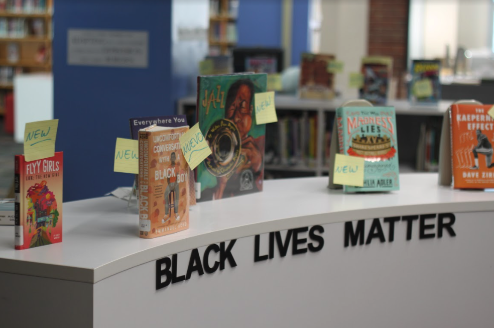 Black lives matter sign in library with books